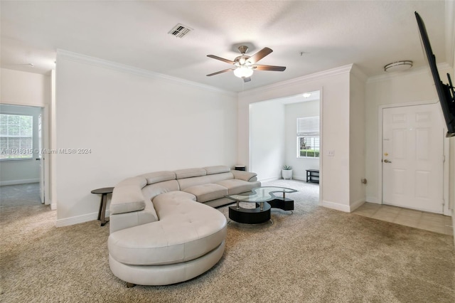 carpeted living room with crown molding, ceiling fan, and plenty of natural light