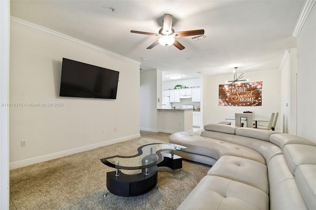 living room featuring ceiling fan with notable chandelier, carpet floors, and ornamental molding