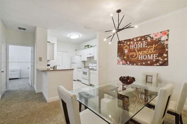 dining space with an inviting chandelier, light colored carpet, ornamental molding, and sink