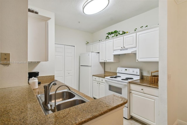 kitchen with kitchen peninsula, sink, white appliances, and white cabinetry