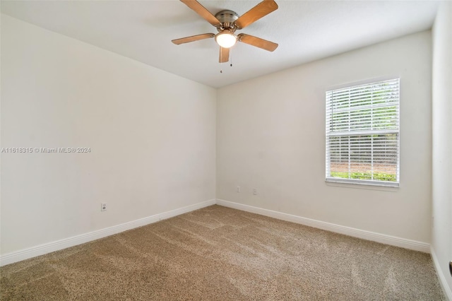 empty room featuring ceiling fan and carpet floors