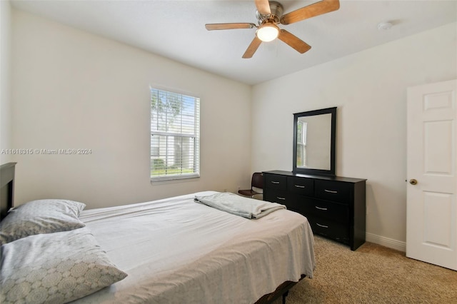 bedroom featuring light carpet and ceiling fan