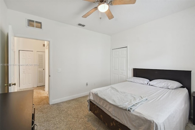 bedroom featuring ceiling fan, light colored carpet, and a closet