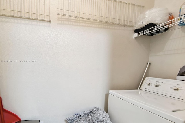 clothes washing area featuring washer / dryer