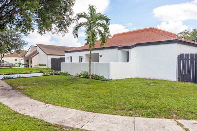 view of property exterior with a lawn