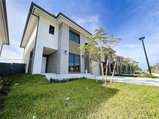 view of front of home with a garage and a front yard