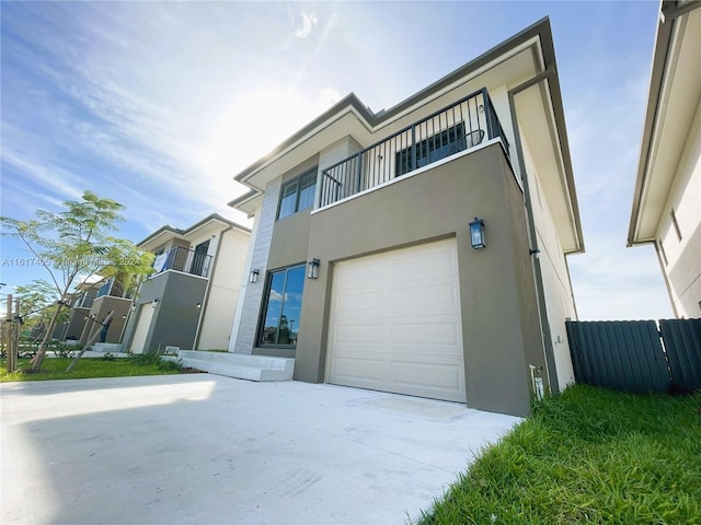 view of front of home with a balcony and a garage