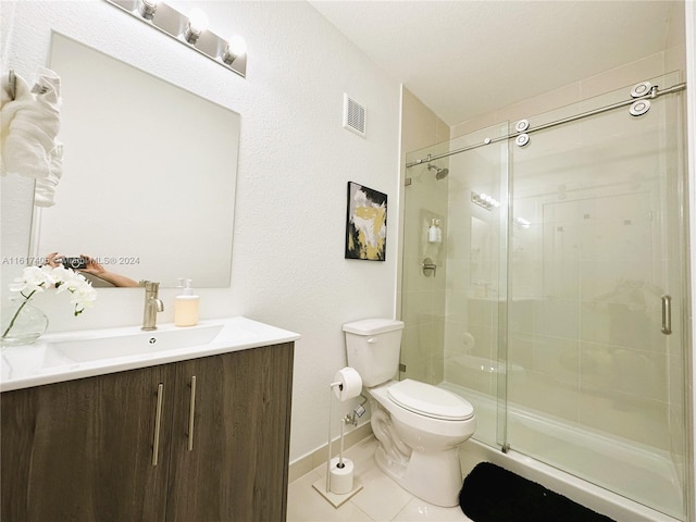 bathroom with vanity, an enclosed shower, tile patterned flooring, and toilet