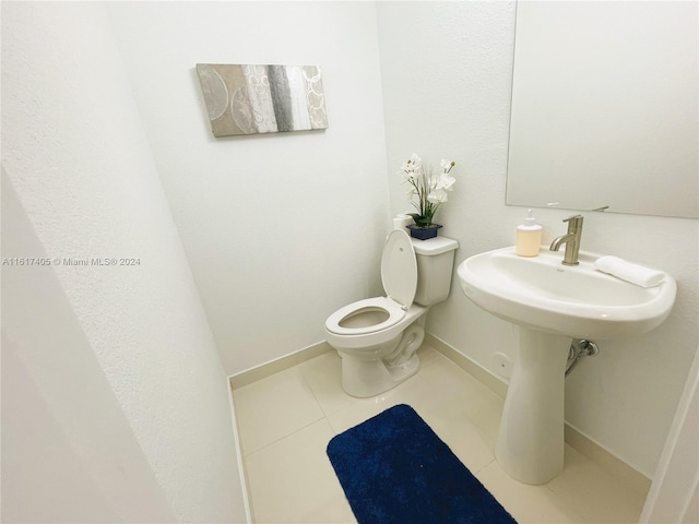 bathroom featuring tile patterned flooring and toilet