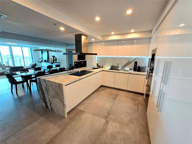 kitchen with extractor fan, white cabinets, kitchen peninsula, decorative backsplash, and black electric cooktop