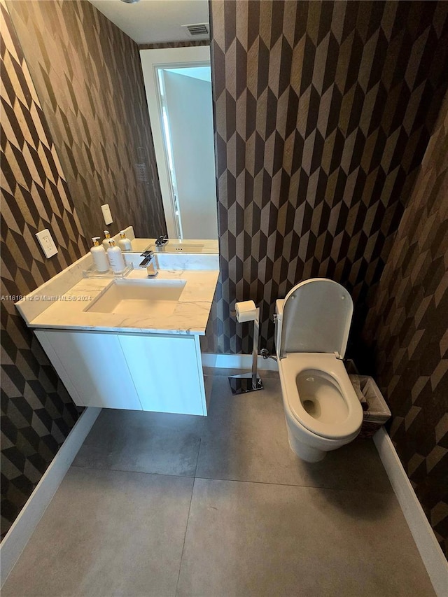 bathroom with vanity, concrete flooring, and toilet