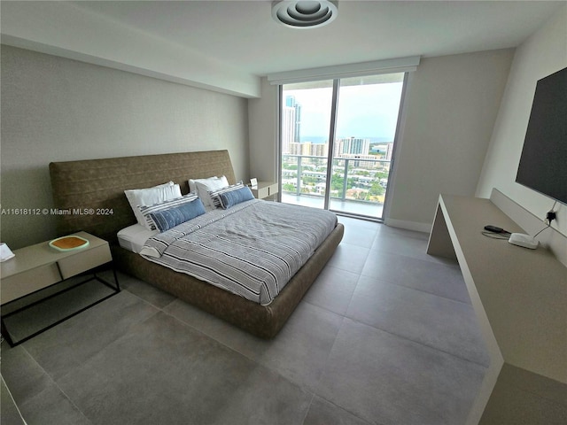 bedroom featuring a wall of windows and access to outside