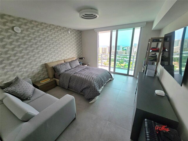 bedroom with tile patterned floors and access to outside