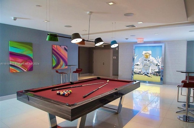 rec room with brick wall, tile patterned floors, and pool table