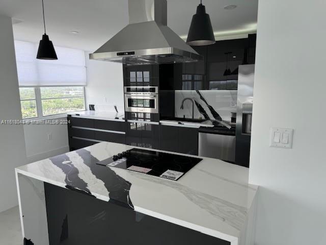 kitchen featuring black electric stovetop, decorative light fixtures, extractor fan, stainless steel fridge with ice dispenser, and sink