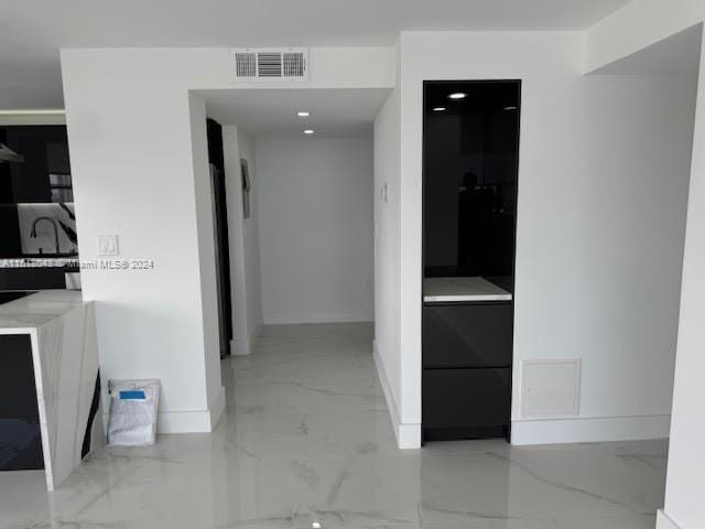 corridor with light tile patterned floors