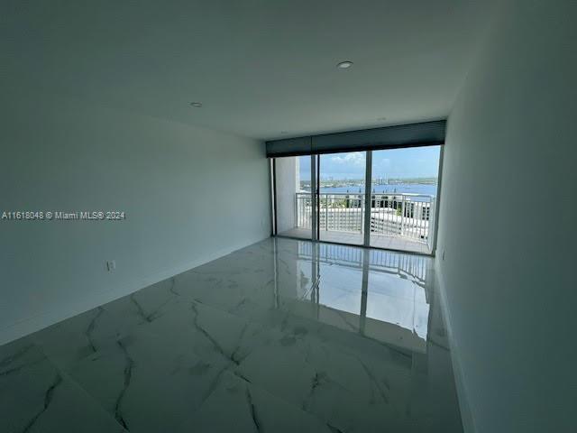 empty room with a water view and expansive windows