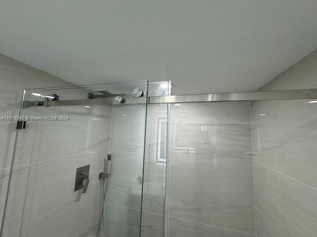 bathroom with a shower with door