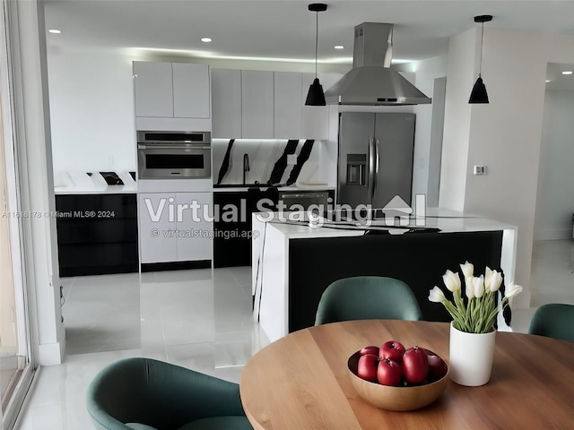 kitchen with gray cabinets, decorative light fixtures, island exhaust hood, appliances with stainless steel finishes, and light tile patterned floors