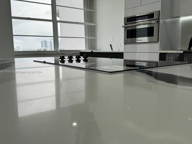 kitchen with white cabinets, concrete floors, and appliances with stainless steel finishes