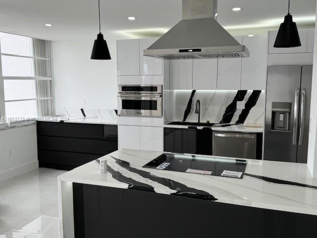 kitchen featuring white cabinetry, pendant lighting, stainless steel appliances, and island exhaust hood