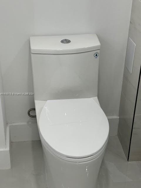 bathroom with toilet and tile patterned floors