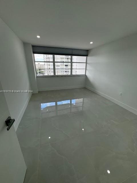 unfurnished room featuring tile patterned flooring