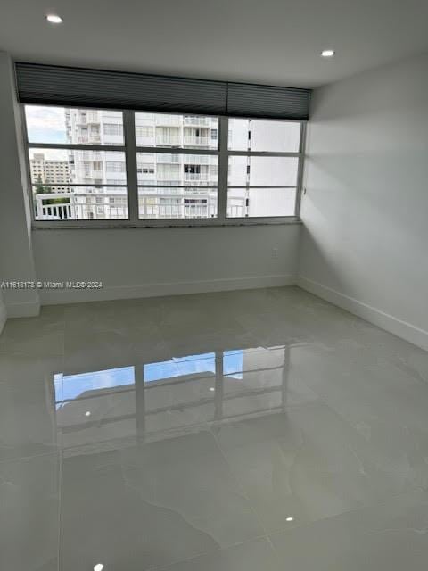 spare room with tile patterned floors