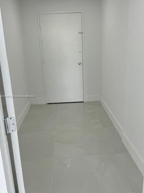 unfurnished room featuring tile patterned floors