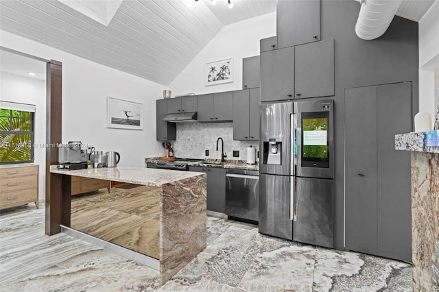 kitchen featuring tasteful backsplash, light stone counters, stainless steel appliances, sink, and wooden ceiling