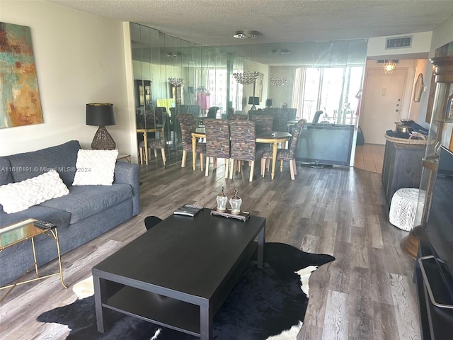 living room with hardwood / wood-style floors and a textured ceiling