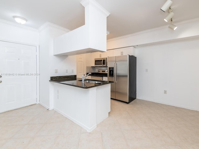 kitchen featuring backsplash, light tile patterned floors, stainless steel appliances, track lighting, and kitchen peninsula