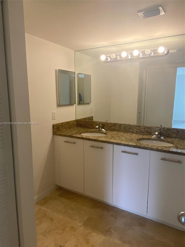 bathroom featuring tile patterned flooring and double vanity