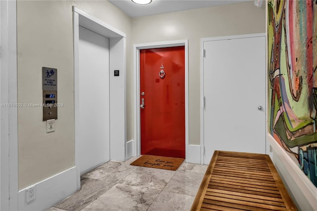 tiled entrance foyer with elevator