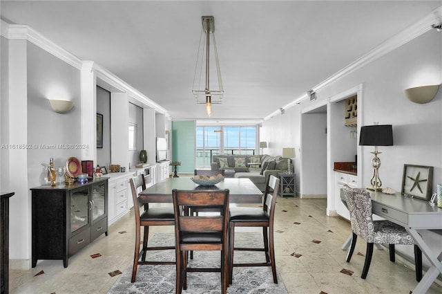 tiled dining room featuring crown molding