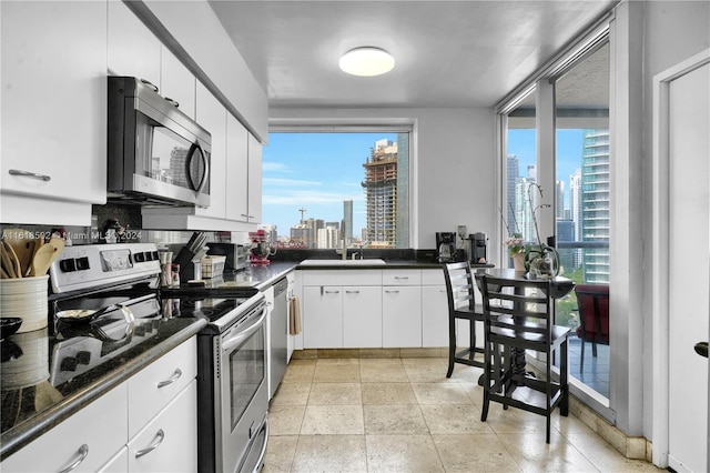 kitchen with white cabinetry, appliances with stainless steel finishes, sink, and plenty of natural light