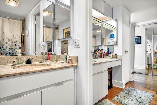 bathroom with vanity and hardwood / wood-style flooring