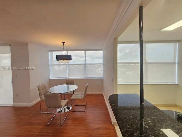 dining area featuring dark hardwood / wood-style floors and ornamental molding