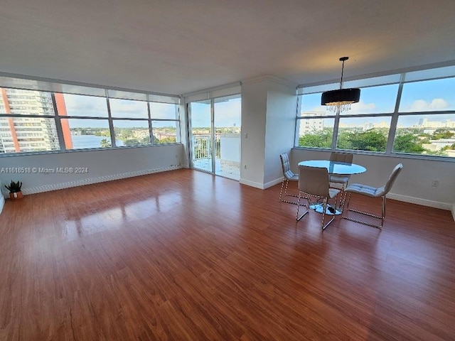 unfurnished sunroom with a water view and a healthy amount of sunlight