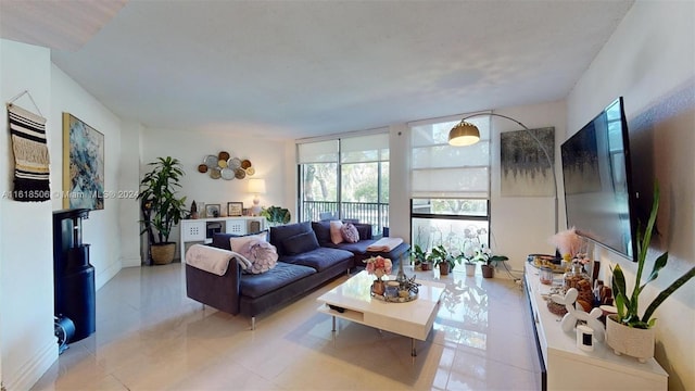 living room featuring light tile patterned floors and a wall of windows