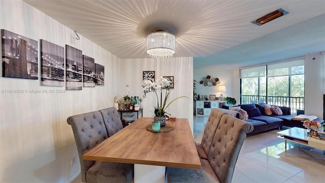 tiled dining space featuring a notable chandelier