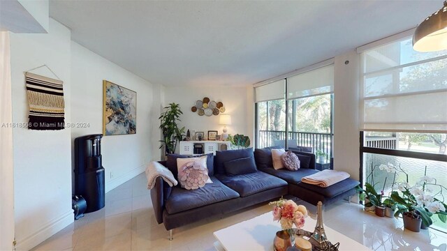 tiled living room with floor to ceiling windows and a wealth of natural light