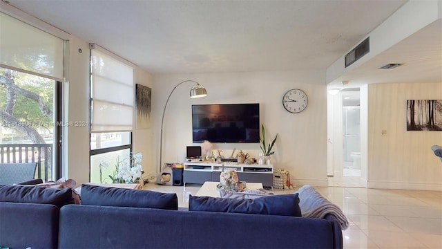 tiled living room with a wall of windows