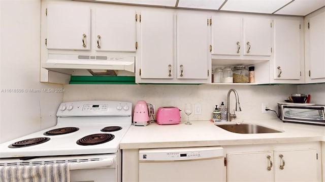 kitchen featuring sink, white appliances, and white cabinets