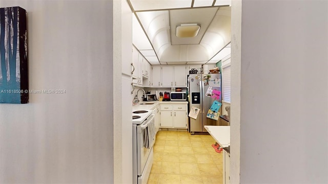 kitchen with stainless steel appliances, sink, and white cabinets