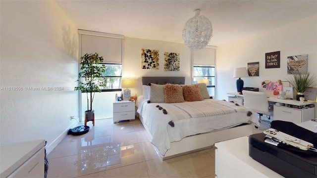 tiled bedroom featuring a notable chandelier