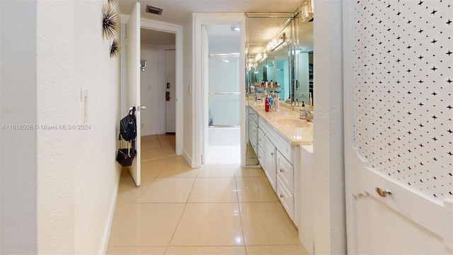 bathroom featuring tile patterned floors, shower / bath combination with glass door, and vanity