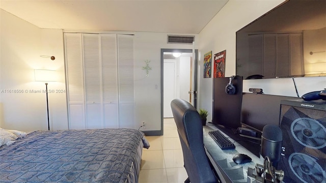 tiled bedroom with a closet