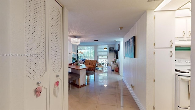 hall featuring light tile patterned flooring