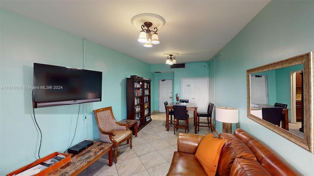 tiled living room with an inviting chandelier